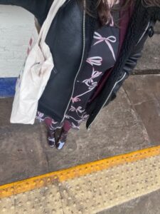 Amy snaps a selfie on a train platform, showing that you can wear what you want with a stoma!