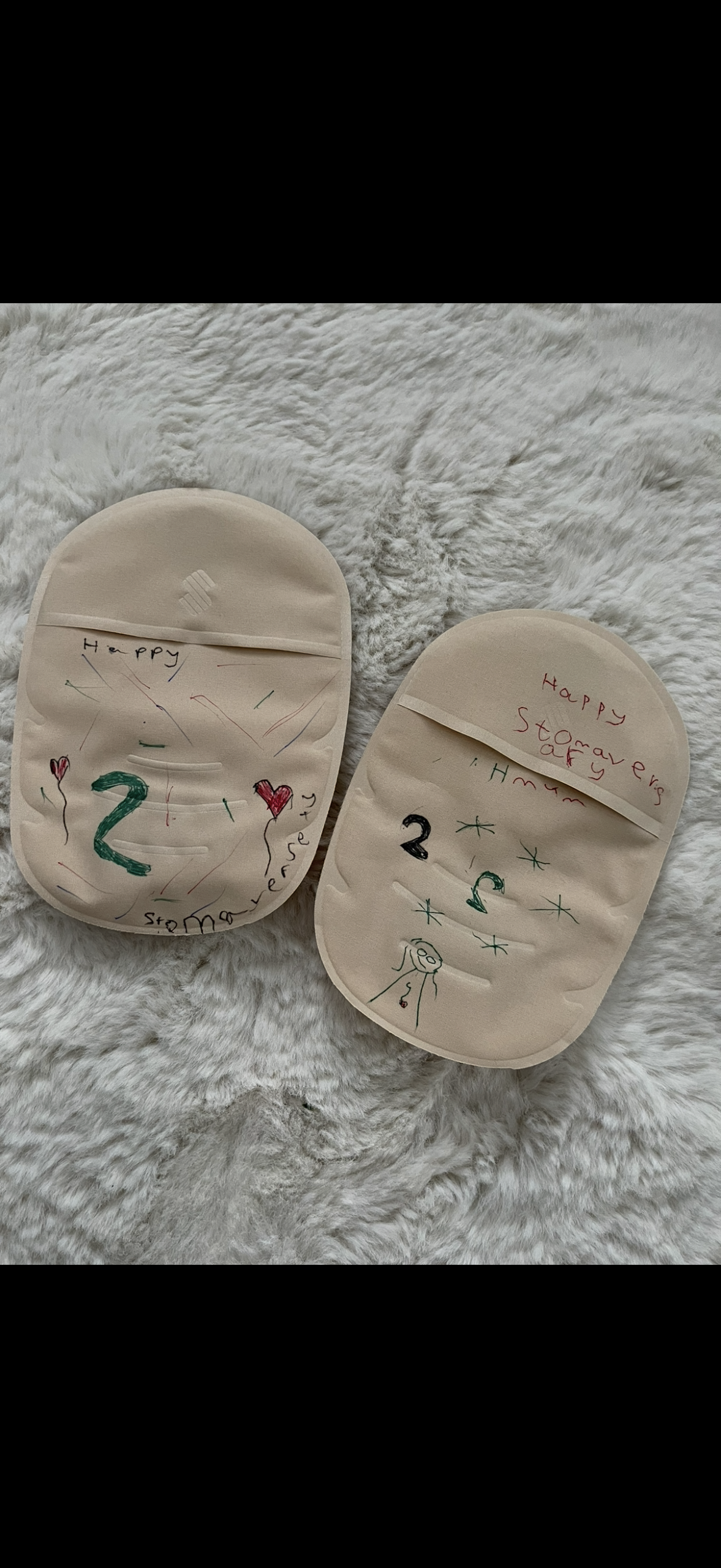 A stoma bag drawn on and coloured by children.
